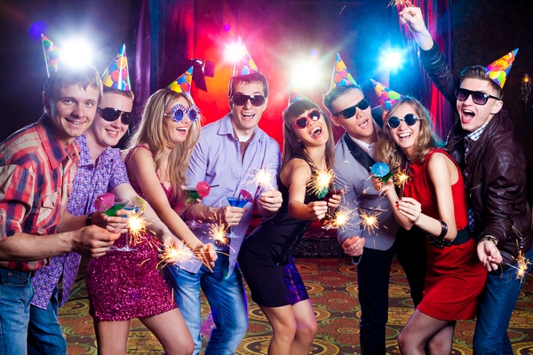 cheerful young company celebrates in a nightclub