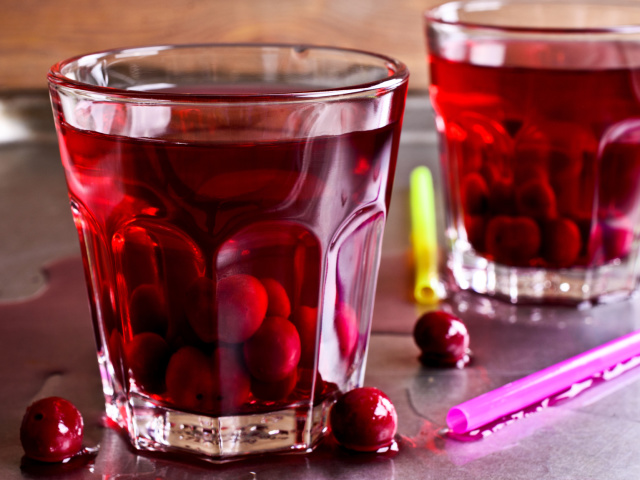 Cherry compote in glass beakers on a metal surface